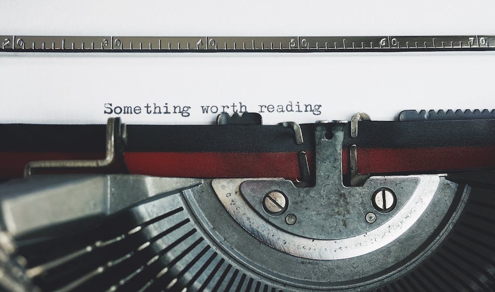 Jenny Laine Designs vintage typewriter with text on page "Something worth reading"